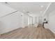 Bright, open-concept living area with hardwood floors, leading to a kitchen with modern appliances at 1366 Penner Dr, Erie, CO 80026