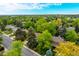Wide aerial shot of a home nestled amongst lush trees in a well-maintained residential area at 9540 E Grand Pl, Greenwood Village, CO 80111