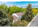 Beautiful aerial view of a white home surrounded by lush green trees in a peaceful neighborhood at 9540 E Grand Pl, Greenwood Village, CO 80111