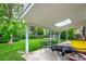 Spacious backyard featuring a covered patio with furniture and a lush lawn at 9540 E Grand Pl, Greenwood Village, CO 80111