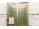 Bathroom with tiled shower, glass doors, and chrome fixtures at 9540 E Grand Pl, Greenwood Village, CO 80111