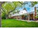 Charming home with a brick and siding exterior, a well-maintained lawn, and mature trees at 9540 E Grand Pl, Greenwood Village, CO 80111