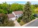 Two-story home with white siding, columns, dark shutters, and mature landscaping at 9540 E Grand Pl, Greenwood Village, CO 80111