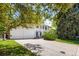 Two-story home featuring a two car garage, mature trees, front yard and a large drive way at 9540 E Grand Pl, Greenwood Village, CO 80111