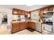 Bright kitchen with wood cabinets, stainless steel appliances, and natural light at 9540 E Grand Pl, Greenwood Village, CO 80111