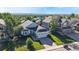 Aerial view of a home with lush landscaping, mature trees and a two-car garage at 15926 Butterwort Cir, Parker, CO 80134