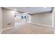 Large finished basement featuring carpet flooring, support columns, and natural light from windows at 15926 Butterwort Cir, Parker, CO 80134