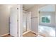 Bathroom with glass shower, wood-look flooring and doorway to bedroom at 15926 Butterwort Cir, Parker, CO 80134