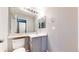 Bathroom features gray vanity, a sink, and tiled shower with neutral wall color at 15926 Butterwort Cir, Parker, CO 80134