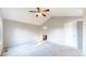 Neutral bedroom with vaulted ceiling, fan, carpet and view to ensuite bathroom at 15926 Butterwort Cir, Parker, CO 80134