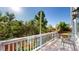 Bright deck overlooking the lush backyard featuring a wooden deck and black metal chairs at 15926 Butterwort Cir, Parker, CO 80134