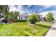 Home featuring a lush lawn, mature trees and a two-car garage at 15926 Butterwort Cir, Parker, CO 80134
