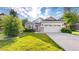 Light exterior of home featuring a well-manicured lawn and a two-car garage at 15926 Butterwort Cir, Parker, CO 80134