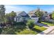 Charming light blue home featuring a manicured lawn, mature trees and a two-car garage at 15926 Butterwort Cir, Parker, CO 80134