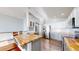 Open kitchen with stainless refrigerator, butcher block counters, and gray cabinets at 15926 Butterwort Cir, Parker, CO 80134