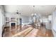 Spacious open-concept living area with hardwood floors, fireplace, and seamless flow to the kitchen at 15926 Butterwort Cir, Parker, CO 80134
