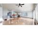 Open concept living room with hardwood floors, large windows and a view of the kitchen at 15926 Butterwort Cir, Parker, CO 80134
