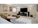 Finished basement with large entertainment center and oversized sectional sofa at 10914 W Coco Pl, Littleton, CO 80127