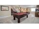 Finished basement featuring a pool table, custom bar, wine storage, and an open layout at 10914 W Coco Pl, Littleton, CO 80127