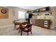 Basement game room featuring a wet bar with ample storage, a dartboard, and a poker table at 10914 W Coco Pl, Littleton, CO 80127