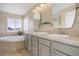 Bathroom featuring dual sinks, tile countertops, soaking tub, and bright natural light at 10914 W Coco Pl, Littleton, CO 80127