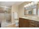 Bathroom featuring a glass door shower, granite countertop vanity, and neutral color palette at 10914 W Coco Pl, Littleton, CO 80127