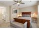 Cozy bedroom featuring a king-sized bed with a decorative bench, and a walk-in closet at 10914 W Coco Pl, Littleton, CO 80127