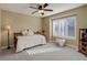 Cozy bedroom with large window and soft, neutral carpet with simple furnishings at 10914 W Coco Pl, Littleton, CO 80127