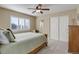Comfortable bedroom with a ceiling fan, large window and large closet space at 10914 W Coco Pl, Littleton, CO 80127