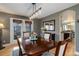 Elegant dining room with dark wood table, stylish lighting, and access to the backyard at 10914 W Coco Pl, Littleton, CO 80127