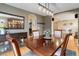 Elegant dining room featuring hardwood floors, a large mirror, and stylish chandelier at 10914 W Coco Pl, Littleton, CO 80127