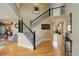 Inviting foyer features a staircase with black iron railing and gleaming hardwood floors at 10914 W Coco Pl, Littleton, CO 80127