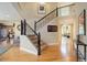 Inviting foyer featuring a staircase with wrought iron spindles and gleaming hardwood floors at 10914 W Coco Pl, Littleton, CO 80127