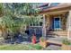 Inviting stone front porch with outdoor seating and well-maintained landscaping at 10914 W Coco Pl, Littleton, CO 80127