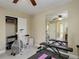 Gym with fan, work out machines, work out bench and mirror for home fitness at 10914 W Coco Pl, Littleton, CO 80127