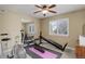Home gym with mirrored wall, ceiling fan, and plenty of space for workout equipment at 10914 W Coco Pl, Littleton, CO 80127