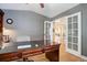 Bright home office with french doors, a large desk, and hardwood floors at 10914 W Coco Pl, Littleton, CO 80127