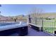 Outdoor hot tub on a deck with mountain and neighborhood views in the background at 10914 W Coco Pl, Littleton, CO 80127