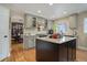 Spacious kitchen with granite countertops, an island, and stainless steel appliances at 10914 W Coco Pl, Littleton, CO 80127