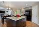 Kitchen island featuring granite countertops and seamless flow into the dining and living areas at 10914 W Coco Pl, Littleton, CO 80127