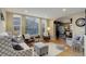 Bright living room with large windows, hardwood floors, and comfortable seating at 10914 W Coco Pl, Littleton, CO 80127
