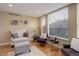 Cozy living room with large window and comfortable seating at 10914 W Coco Pl, Littleton, CO 80127