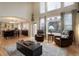 Open concept living room with hardwood floors, large windows, and adjoined kitchen at 10914 W Coco Pl, Littleton, CO 80127