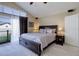 Comfortable main bedroom with a large bed, balcony access and an en suite bathroom at 10914 W Coco Pl, Littleton, CO 80127