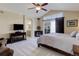 Main bedroom featuring vaulted ceiling, ceiling fan, sitting area, and ensuite bathroom at 10914 W Coco Pl, Littleton, CO 80127