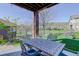 Covered outdoor dining area with wrought iron table and chairs with seating for four at 10914 W Coco Pl, Littleton, CO 80127