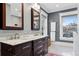 Modern bathroom with double vanity, marble countertops, and a tiled shower at 750 N Clarkson St, Denver, CO 80218