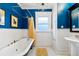 Vintage bathroom with clawfoot tub and blue walls at 750 N Clarkson St, Denver, CO 80218