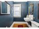 Stylish bathroom with a pedestal sink and dark blue walls at 750 N Clarkson St, Denver, CO 80218