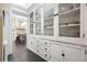 Bright butler's pantry with white cabinets and glass-front doors at 750 N Clarkson St, Denver, CO 80218